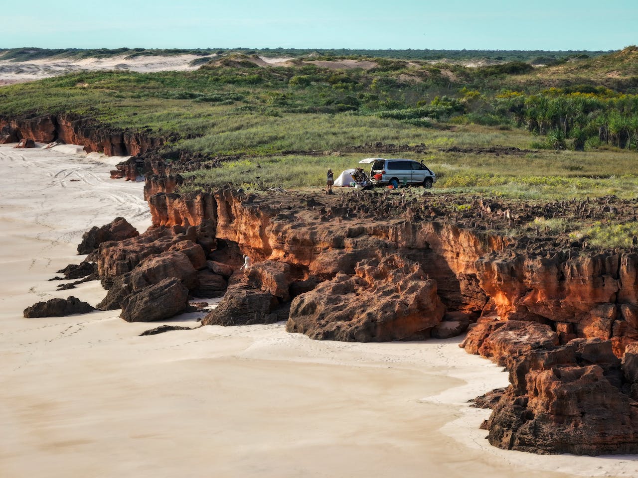 services-01 Scenic aerial view of campervan and tent on Dampier Peninsula cliffs, Western Australia.